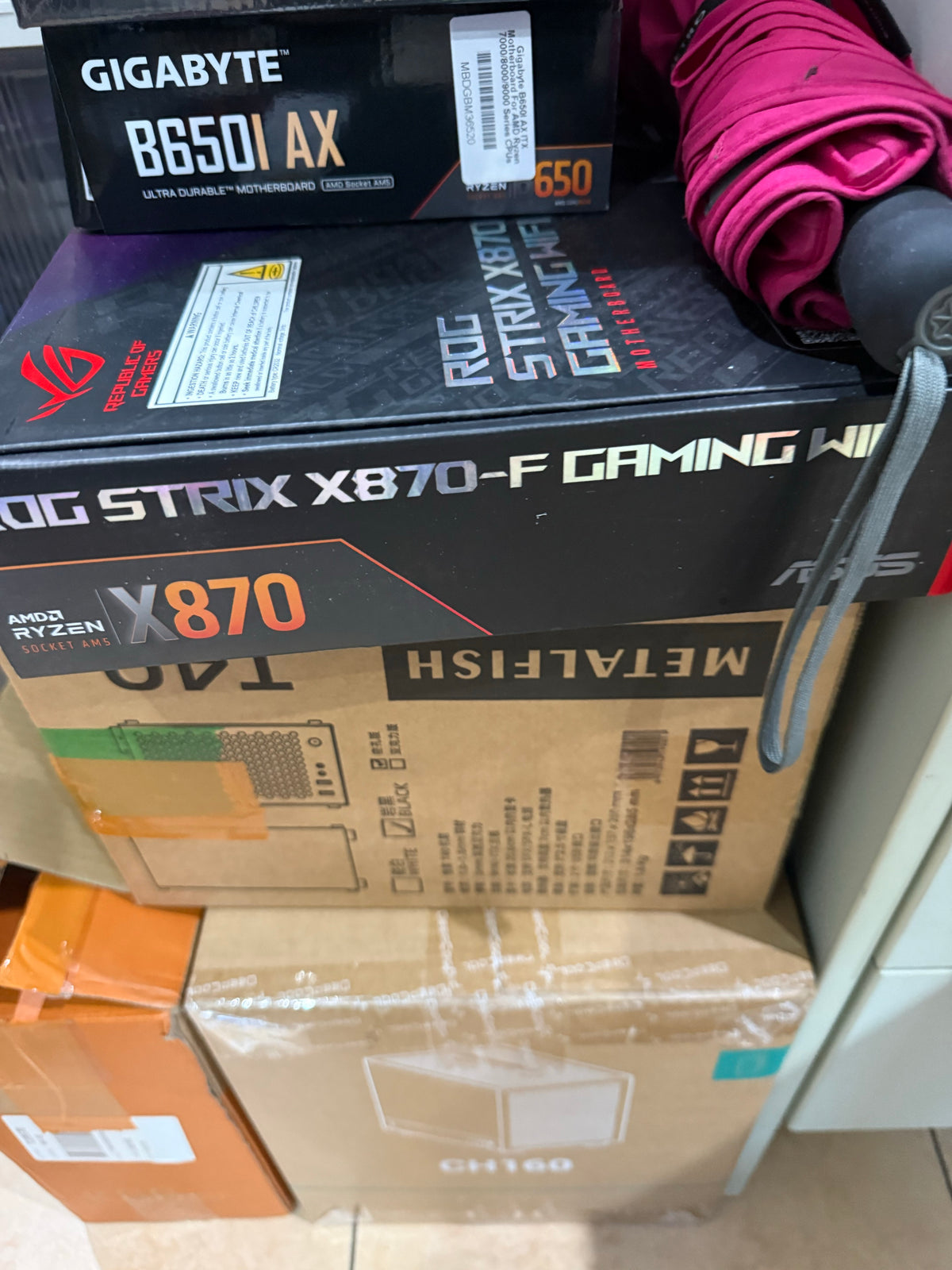 Actual Gigabyte B650I AX packaging shown with another motherboard box