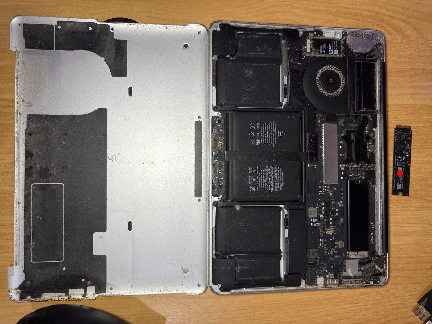 MacBook Pro A1502 opened at XtremeSystem Auckland with the original SSD removed during replacement